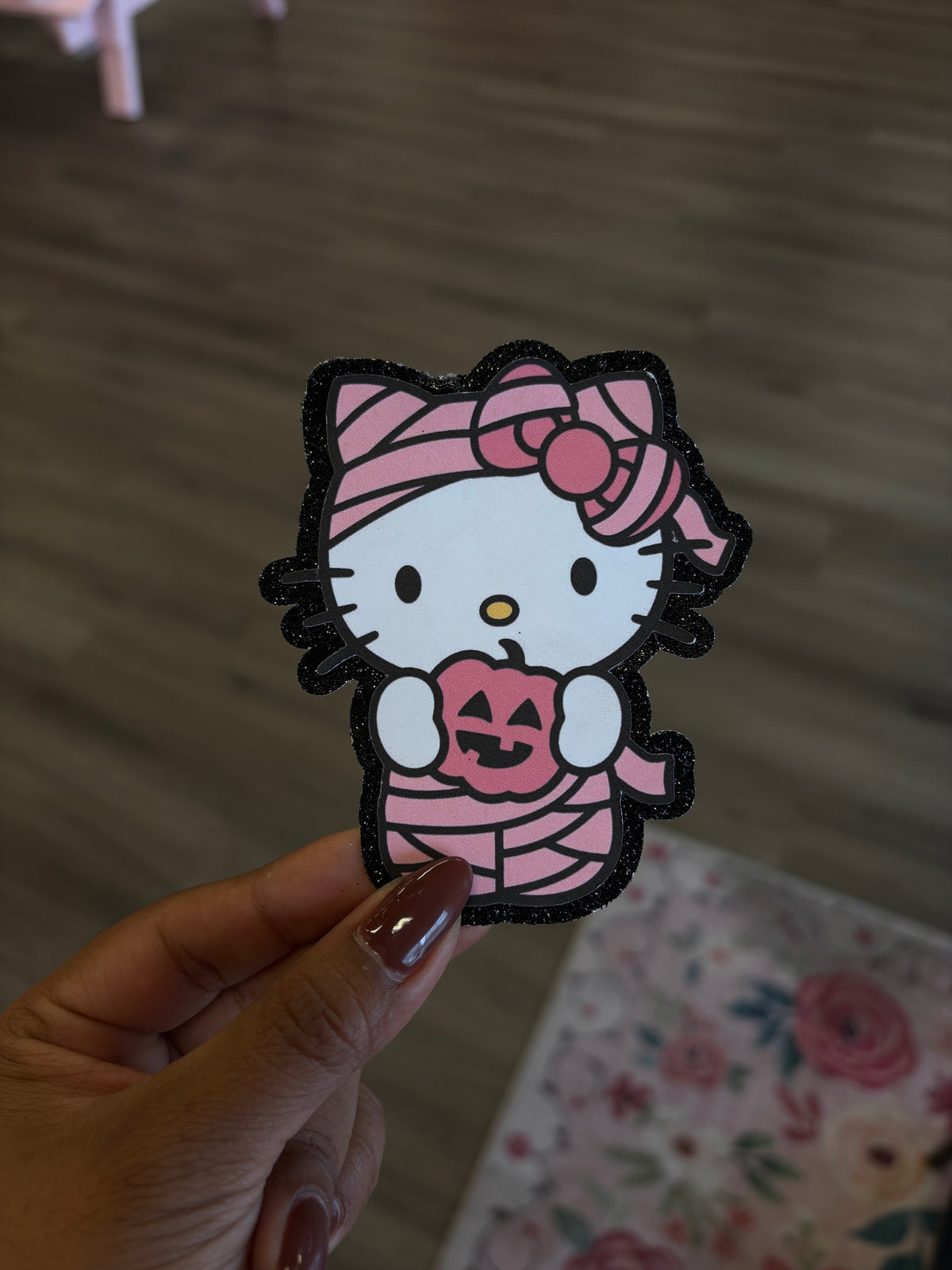1Hello Kitty mummy with black glitter background