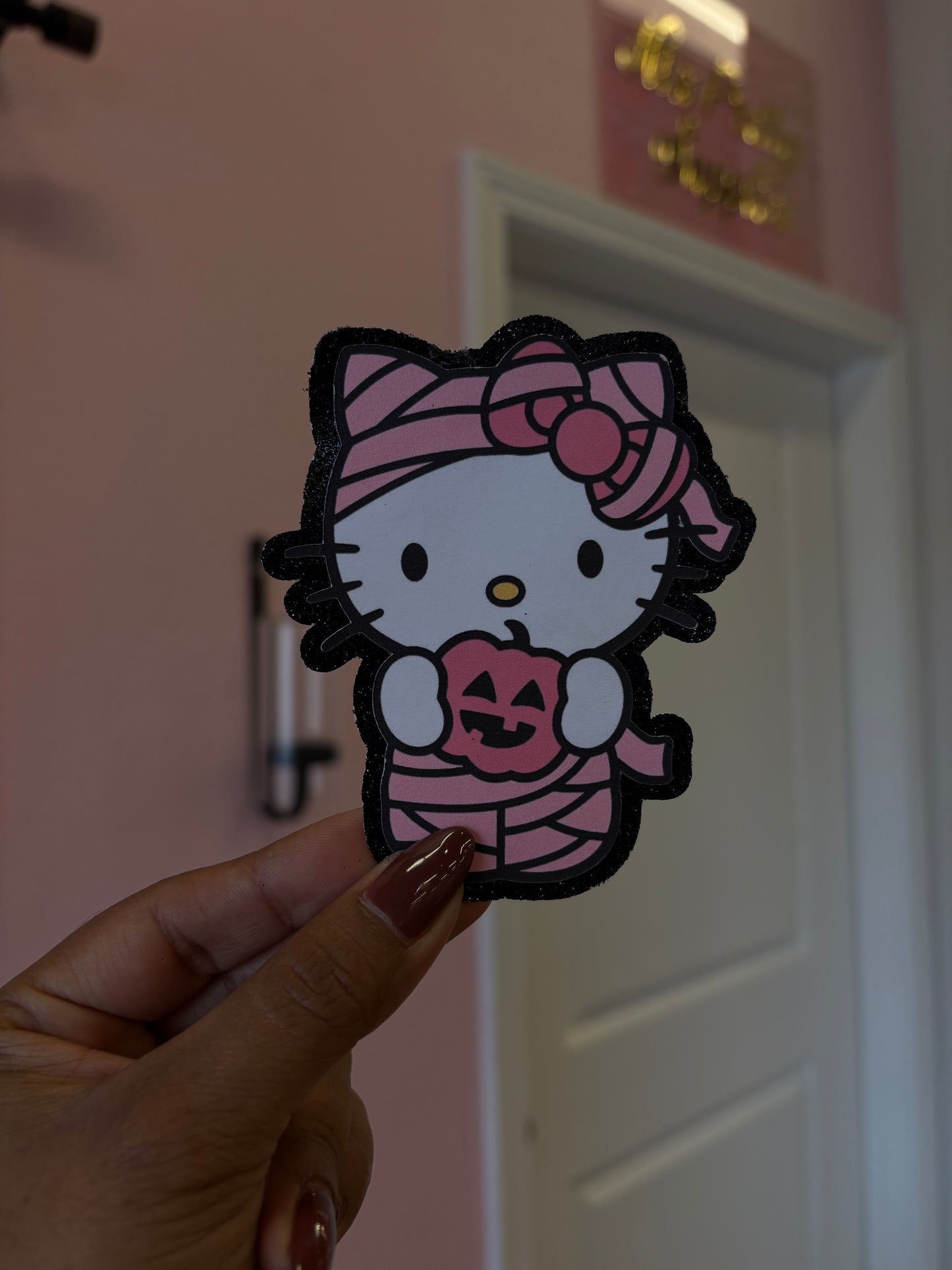 1Hello Kitty mummy with black glitter background
